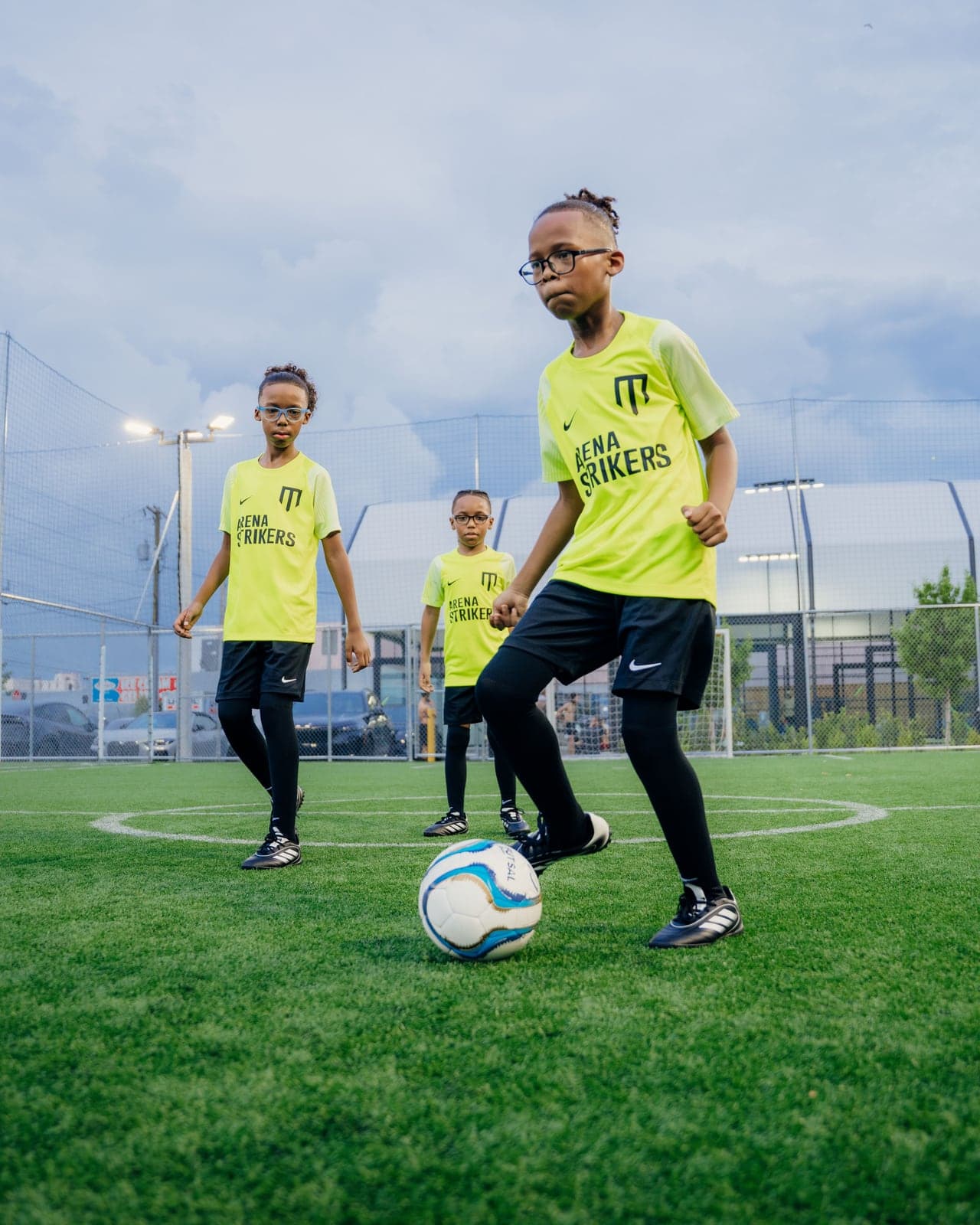 Arena Strikers player controlling the ball with teammates behind him at Arena SSC Wynwood, Miami
