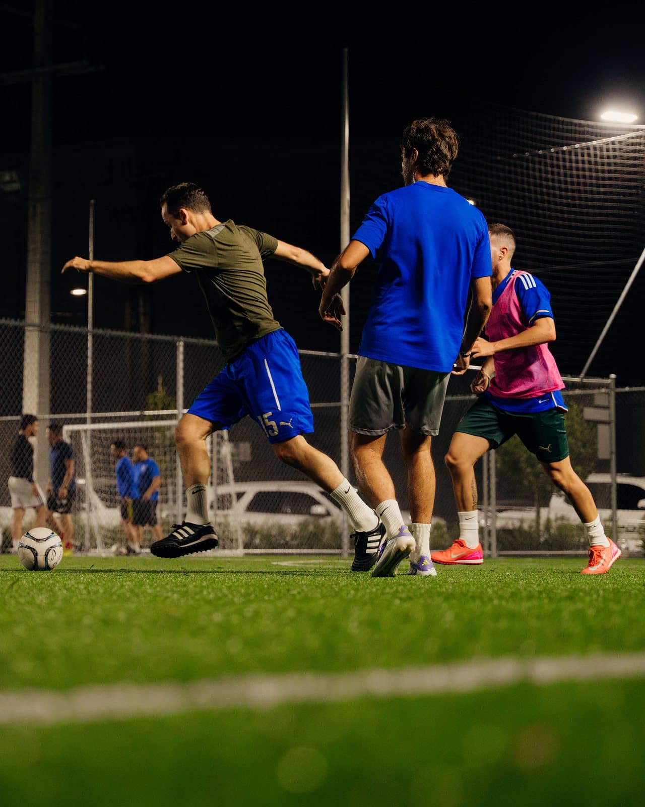 A player winds up to shoot during a night game on an outdoor turf field at Arena SSC Wynwood, Miami