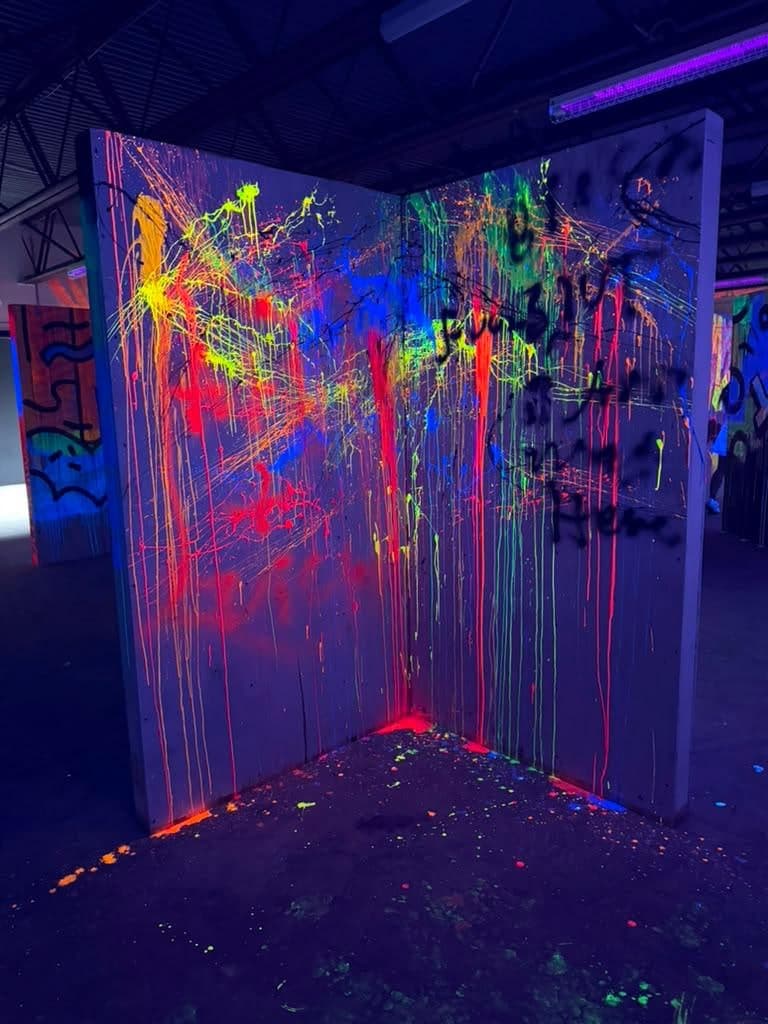The laser tag arena at Arena SSC Wynwood: fluorescent graffiti walls and barriers under blacklight (3 of 9)