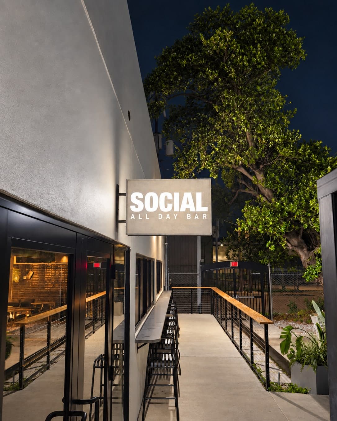 The SOCIAL all day bar sign over the entrance walkway at Arena SSC Wynwood
